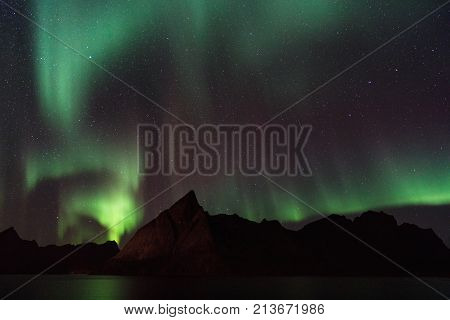 Northern lights over Olstind mountain Lofoten Norway