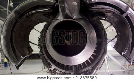 Engine of the airplane under heavy maintenance. Aircraft maintenance, dismantled plane engine. Chassis of the airplane under heavy maintenance 4K