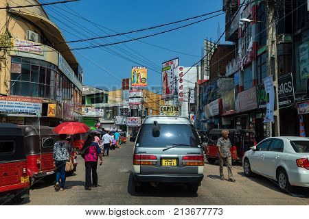 NEGOMBO, SRI LANKA - DECEMBER, 2016: view of typical street with people and vehicles