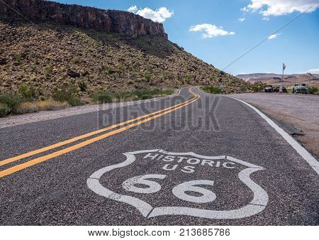 Route 66 painted on the aphalt in Arizona near Oatman with blue sky