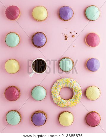 small colored brewed cakes and a cup of coffee. Geometry of a circle.