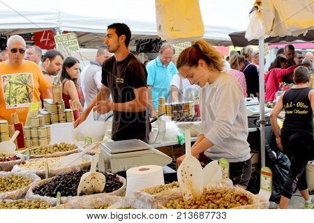 Valras-plage, Herault, France - Aug 25 2017: Man And Woman Serving A Large Range Of Olives To Severa