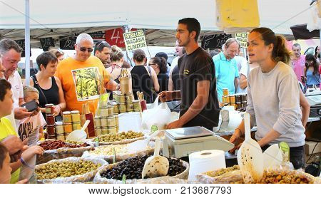 Valras-plage, Herault, France - Aug 25 2017: Man And Woman Serving A Large Range Of Olives To Severa