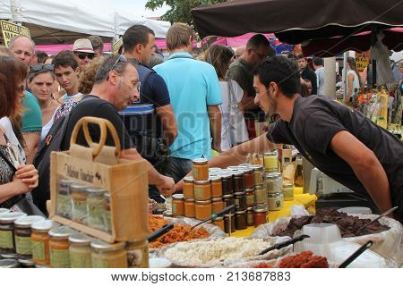 Valras-plage, Herault, France - Aug 25 2017: French Market Trader Selling Jars Of 