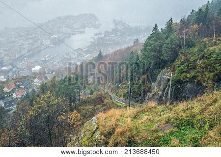 The Floibanen funicular tracks leading to the top of the Mount Floyen on a gloomy rainy day, Bergen, Norway