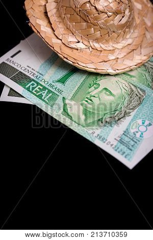 brasil money on a black background with a straw hat concept holiday or travel