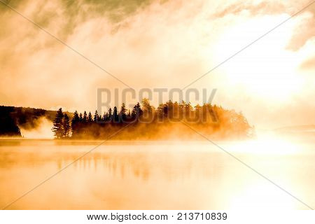 Lake of two rivers in algonquin national park ontario canada sunset sunrise with fog foggy mystical atmosphere background