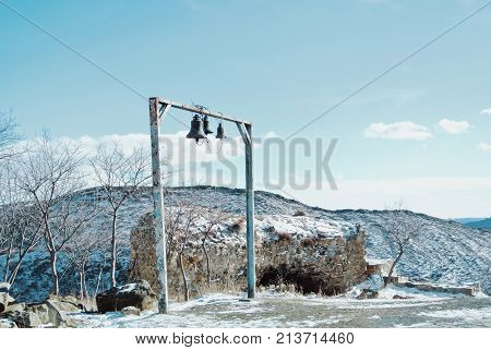 Three Bells And The Ruins Of A Brick Wall Near The Jvari Orthodox Monastery Near Mtskheta, Eastern G