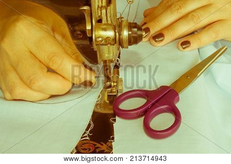 closeup of woman hands sewing yellow cloth outdoors. Woman's Hand Sewing Quilt - Retro color