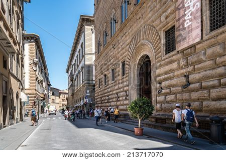 Florence, Italy - August 23, 2016: Palazzo Strozzi in Florence a sunny day of summer. It is a renaissance palace and an example of civil architecture with its rusticated stone.