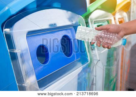 Man Hand Putting Plastic Reuse  For Recycling Concept Environmental Protection World Recycle