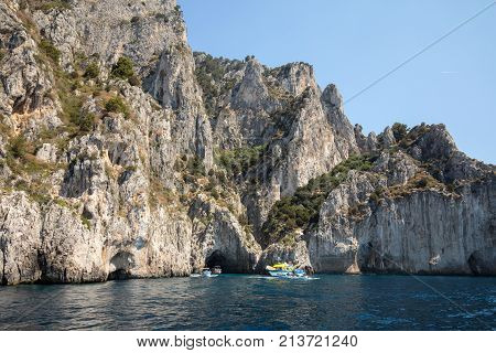 CAPRI ITALY - JUNE 13 2017: Boats with tourists near Grotta Bianca and Grotta Meravigliosa Capri Italy