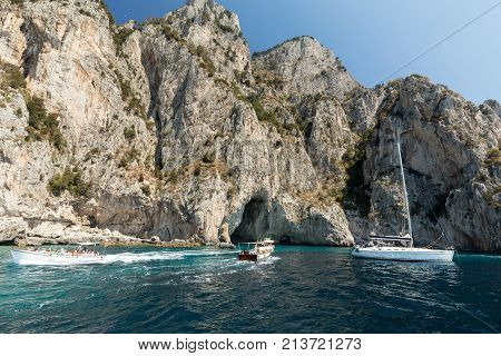 CAPRI ITALY - JUNE 13 2017: Boats with tourists near Grotta Bianca and Grotta Meravigliosa Capri Italy