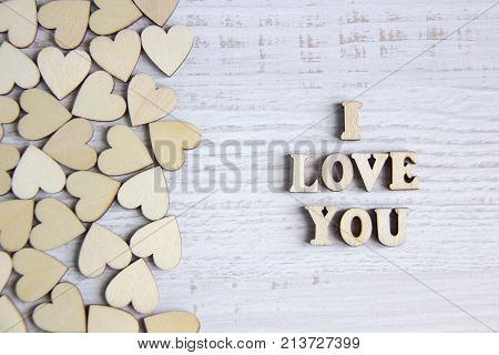 Heart shape from natural tree. Lovely heart shape by wooden small hearts on rustic wood table. Love theme concept with wooden hearts for Valentine's background and love theme. wooden leters i love you.
