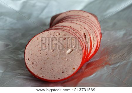 Ham sausage on the paper from the butcher