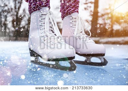 Close-up of woman ice skating on a pond on a freezing winter day
