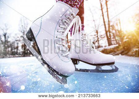 Close-up of woman ice skating on a pond on a freezing winter day