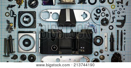 Parts Old Retro Film Slr Camera On Graph Paper