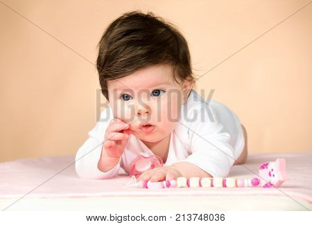 Bright blue eyed beauity 6 month old baby girl.