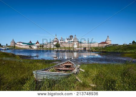 Old wooden boat in front of Ancient Solovetsky Monastery on the Big Solovetsky Island Notern Russia