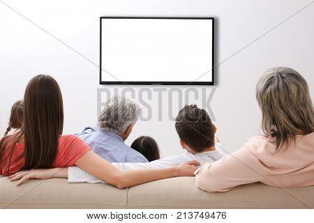 Family and blank TV display at home