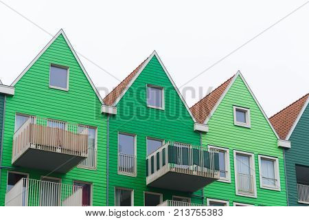 green facades of typical dutch houses in zaanstad netherlands