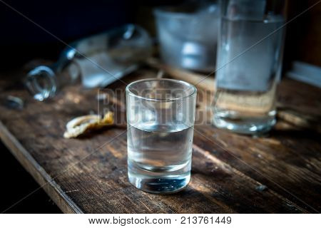 A Small Stack Of Vodka Close Up On The Old Dirty Wooden Table
