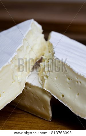 Close Up Of Camembert Cheese. Brie With Coarse Edge Broken Into Pieces Cremy And Delicious.