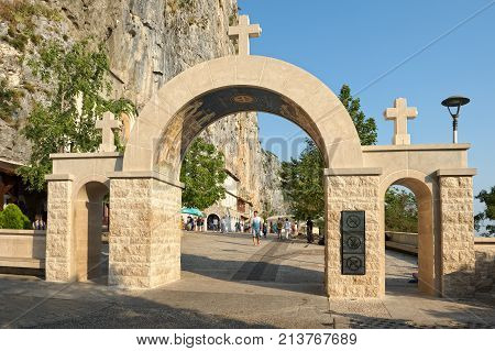 MONTENEGRO, DANILOVGRAD - AUGUST 10, 2017: View of the main gate to the inner courtyard of the Orthodox male Ostrog monastery