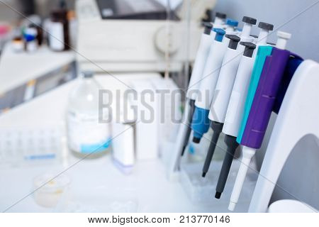 Get tested. Clean current medical pipettes affixed to the stand hanging above the table while medications placed on the background