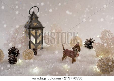 New Year card with toy dog in a fairy forest on winter background with snow and lights. Template greeting card