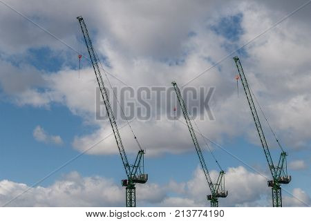 Three cranes with Blue sky and cloud background