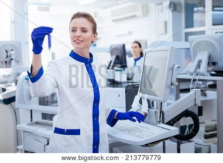 I need this. PSA test conducted by gorgeous blond female lab assistant who carrying the glassware and getting away from the computer