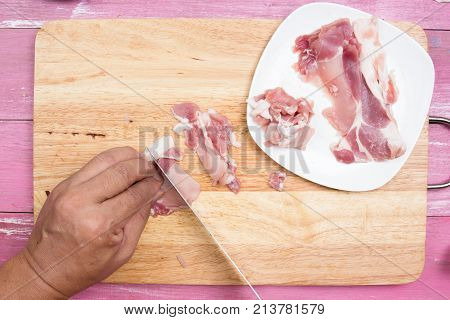 Chef sicing pork for cooking / Cooking Yakisoba concept