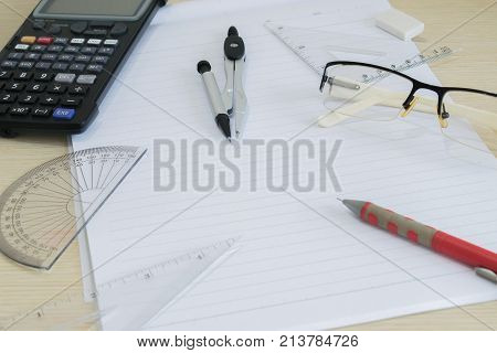 measurement pencil calculator glasses and paper on the desk ; Prepare drawing and calculate