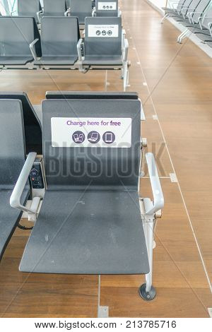 Heathrow Terminal 5 London UK - September 25 2017: Inside Terminal 5 charging your technology seat. Empty seat in charging area.