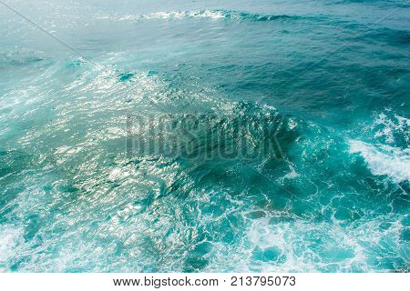 Adriatic Sea in windy weather. Waves and foam sun glare on the water. View from above.