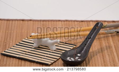 Wooden chopsticks on white porcelan 