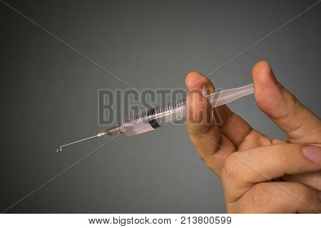 syringe with a needle for a prick in the hand