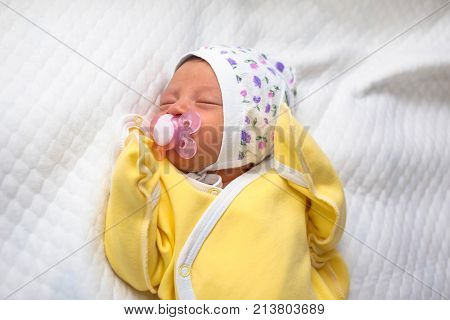 Newborn baby sucks a nipple. Newborn baby sleeps sweetly. New life tiny baby.