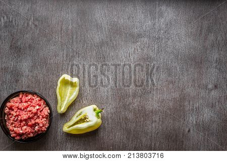 Composition of raw meat with vegetables and spice on wooden background. Top view. Copy space. Still life. Flat lay.