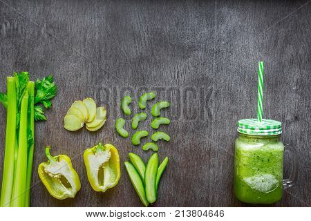 Green vegetable smoothie with celery, ginger and cucumber. Top view. Copy space. Still life. Flat lay.