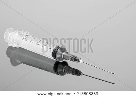 medical syringe close-up with reflection on glass