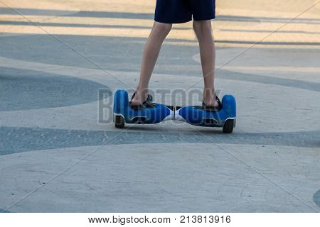 Legs Of Boy Riding On Self-balancing Mini Hoverboard In The City Street