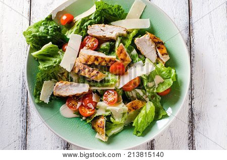 Grilled chicken salad with tomatoes and parmesan cheese