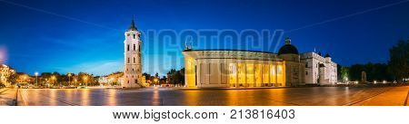 Vilnius, Lithuania, Eastern Europe. Evening Night Panorama Of Bell Tower Belfry, Cathedral Basilica Of St. Stanislaus And St. Vladislav And Palace Of The Grand Dukes Of Lithuania In Twilight. UNESCO