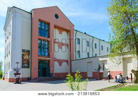 POLOTSK BELARUS - MAY 19 2017: Unknown people are near building of Art Gallery and monument to Krivichi - founders of Polotsk Belarus