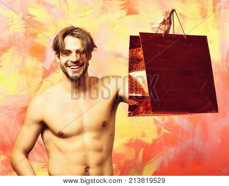 Caucasian Bearded Sexy Macho Man Holding Red Package Or Bag