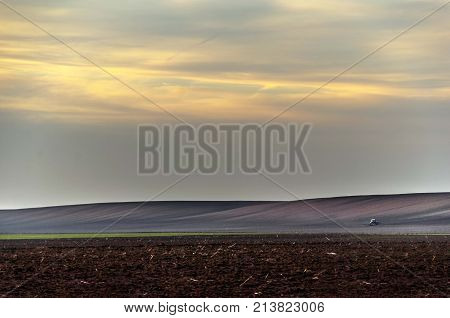 agriculture arable land field with sky clouds. agricultural landscape