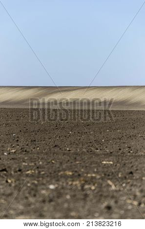 agriculture arable land field with sky clouds. agricultural landscape